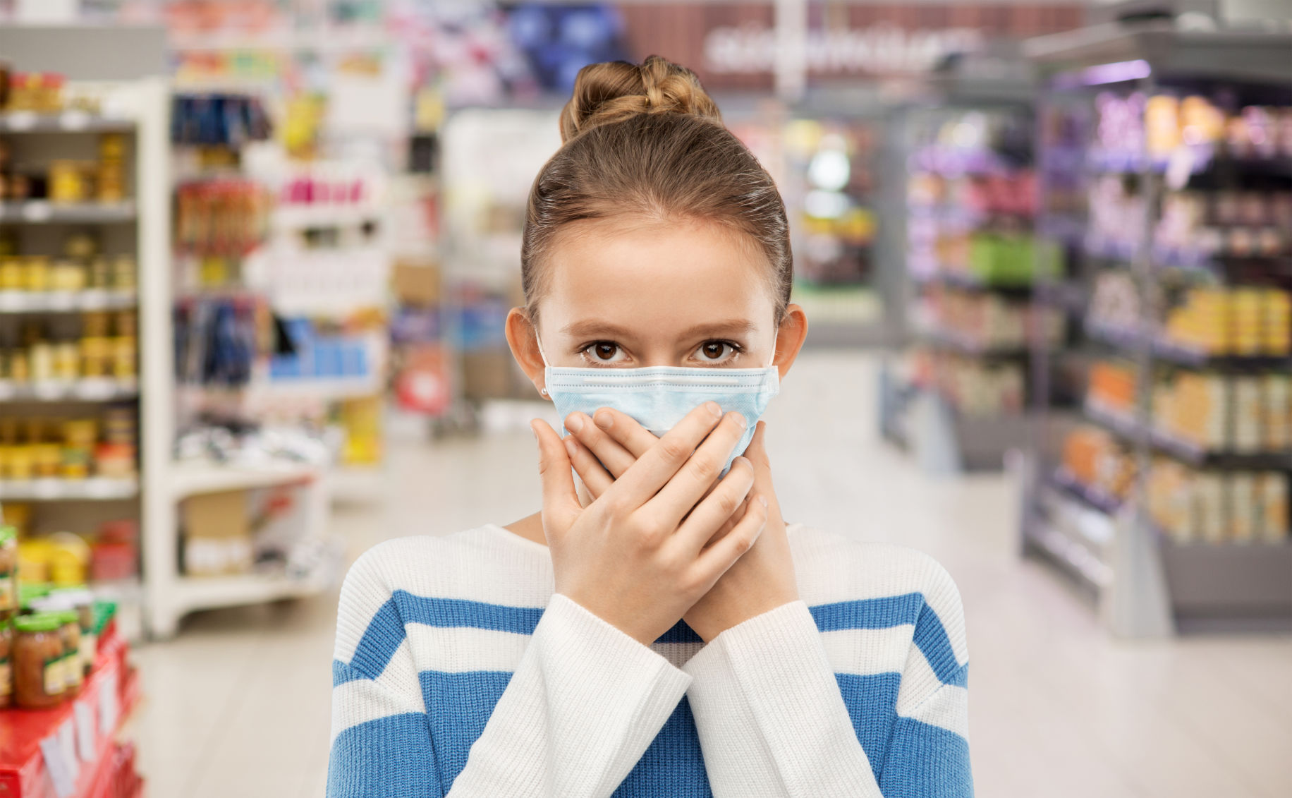 teenage girl in medical mask at supermarket